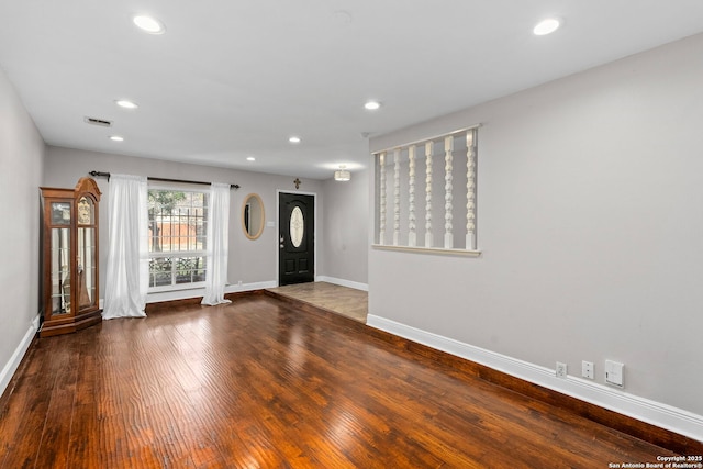 foyer featuring recessed lighting, wood finished floors, visible vents, and baseboards