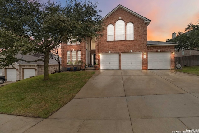 view of front of house with a garage and a yard