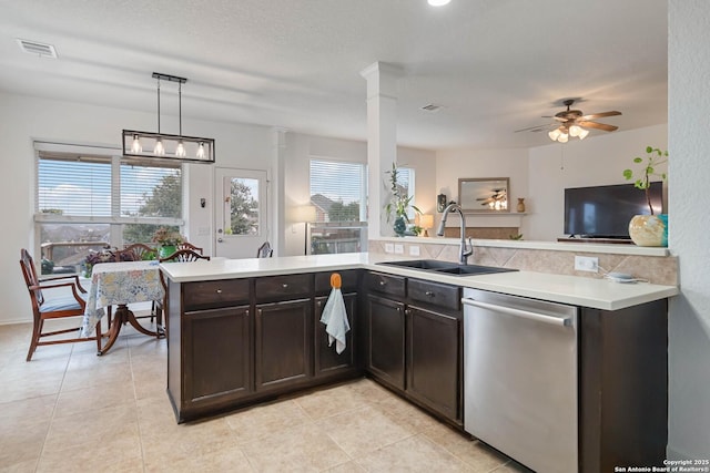 kitchen featuring dark brown cabinets, stainless steel dishwasher, decorative light fixtures, ceiling fan, and sink