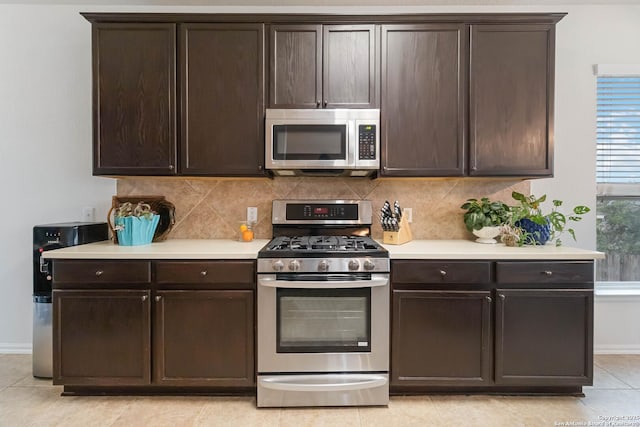 kitchen with backsplash, stainless steel appliances, and dark brown cabinetry