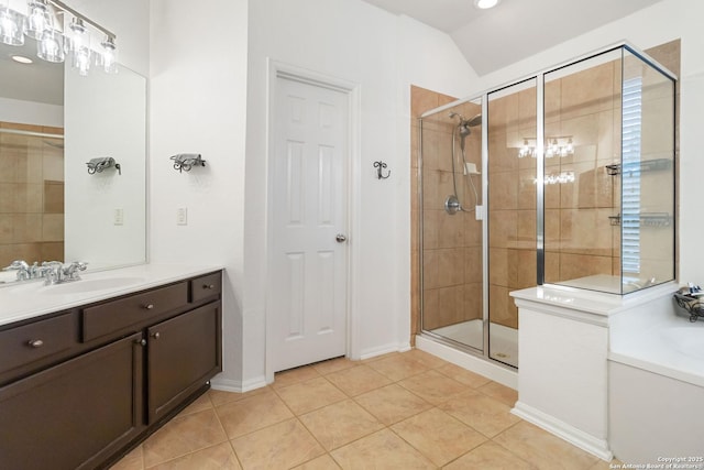 bathroom with tile patterned floors, lofted ceiling, a shower with shower door, and vanity