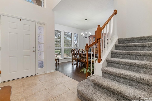 tiled entrance foyer featuring a notable chandelier