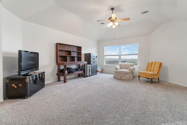 sitting room featuring vaulted ceiling, carpet flooring, ceiling fan, and a raised ceiling