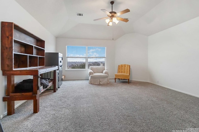 sitting room with ceiling fan, carpet floors, and lofted ceiling
