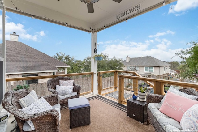 wooden terrace with ceiling fan and an outdoor hangout area