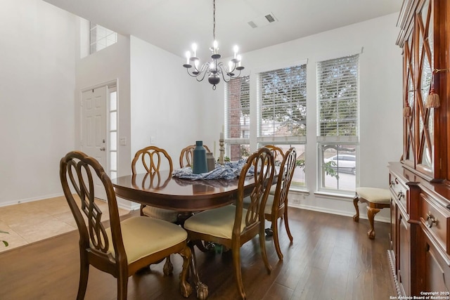 dining area featuring a chandelier and dark hardwood / wood-style floors