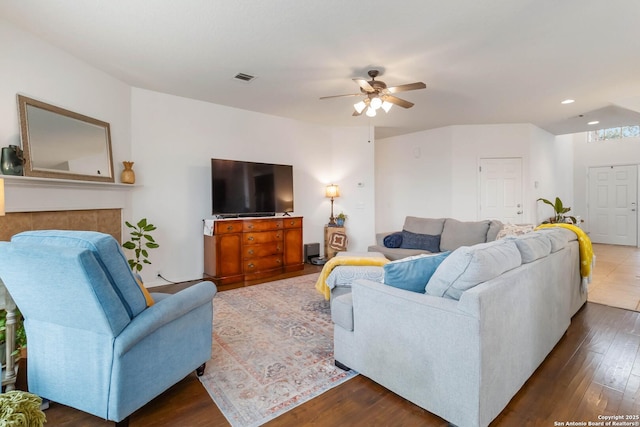 living room with ceiling fan and dark hardwood / wood-style floors