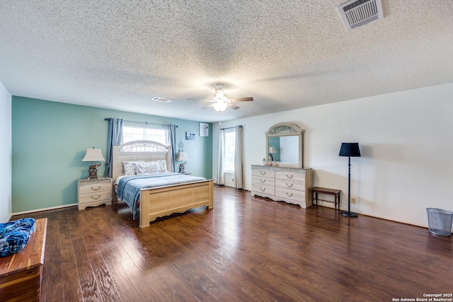 bedroom featuring a textured ceiling, dark hardwood / wood-style floors, and ceiling fan