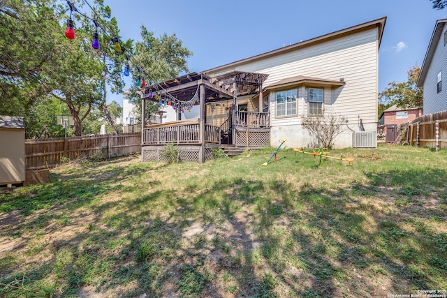 back of house with cooling unit, a deck, a pergola, and a lawn