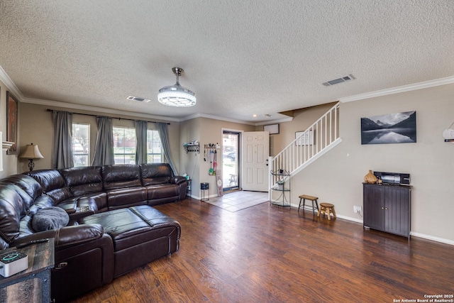 living room featuring dark hardwood / wood-style flooring, ornamental molding, and a textured ceiling