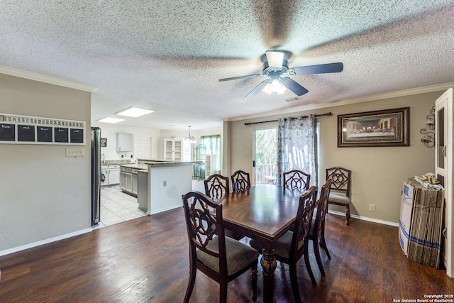 dining room with ceiling fan with notable chandelier, light wood-type flooring, crown molding, and a textured ceiling