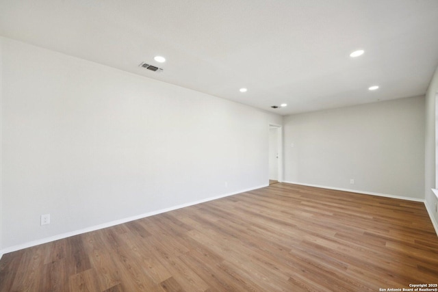 spare room featuring light wood-type flooring