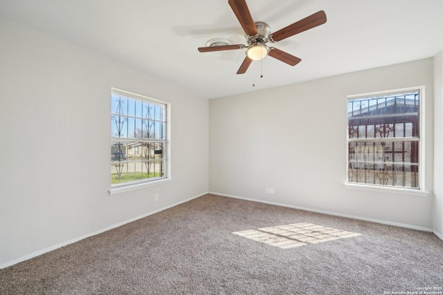 carpeted empty room with a healthy amount of sunlight and ceiling fan