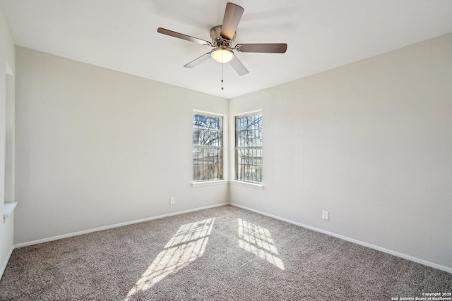 carpeted spare room with ceiling fan