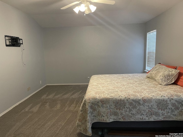 carpeted bedroom with vaulted ceiling and ceiling fan