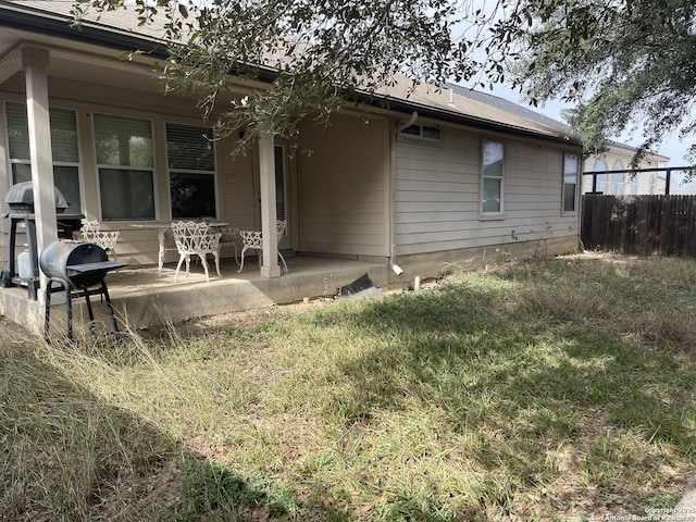 rear view of property with a yard and a patio