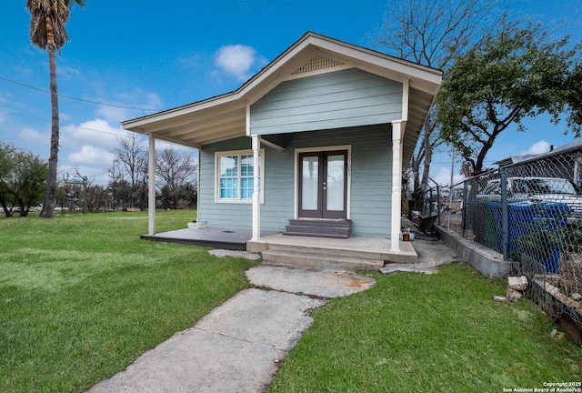 bungalow with a front lawn and a porch