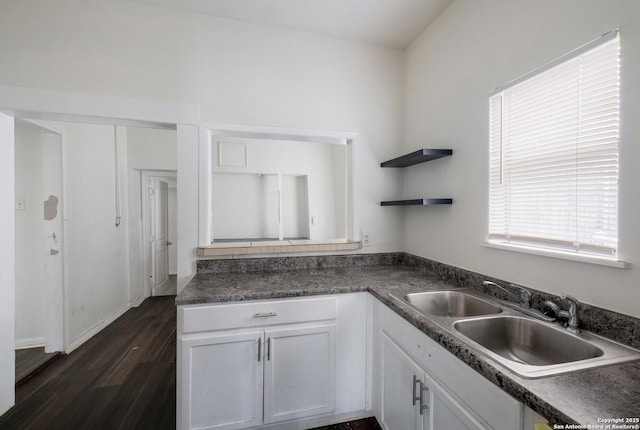 kitchen featuring white cabinetry, sink, and dark wood-type flooring