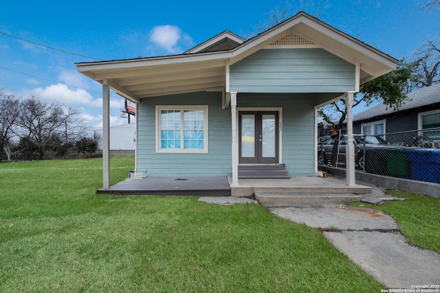 bungalow with a front lawn and french doors