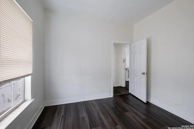 unfurnished room with dark hardwood / wood-style floors