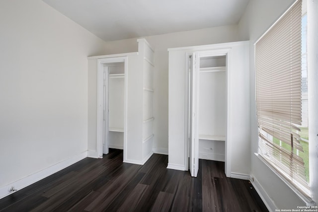 unfurnished bedroom featuring a closet and dark hardwood / wood-style floors