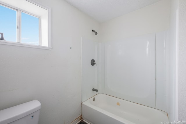 bathroom with shower / bathtub combination and toilet