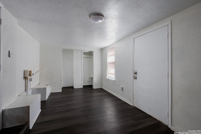 foyer featuring dark wood-type flooring and a textured ceiling