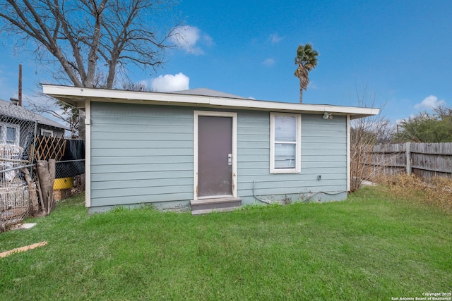 view of outbuilding featuring a lawn