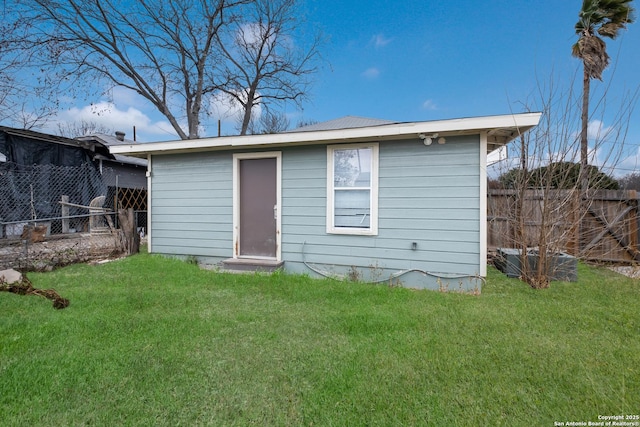 rear view of property with a lawn