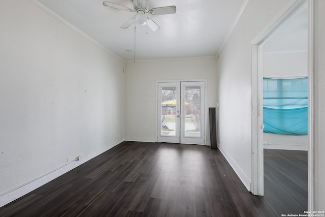 empty room with ornamental molding, french doors, dark hardwood / wood-style floors, and ceiling fan