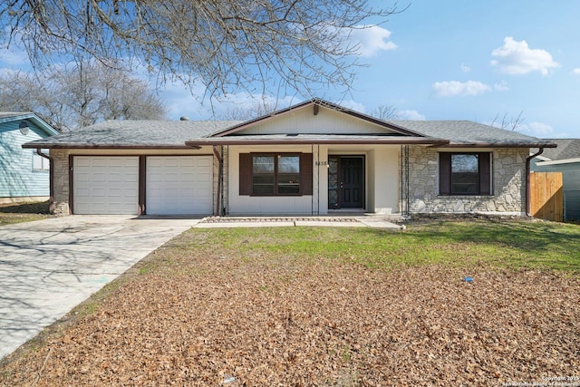 ranch-style home featuring covered porch, a front yard, and a garage