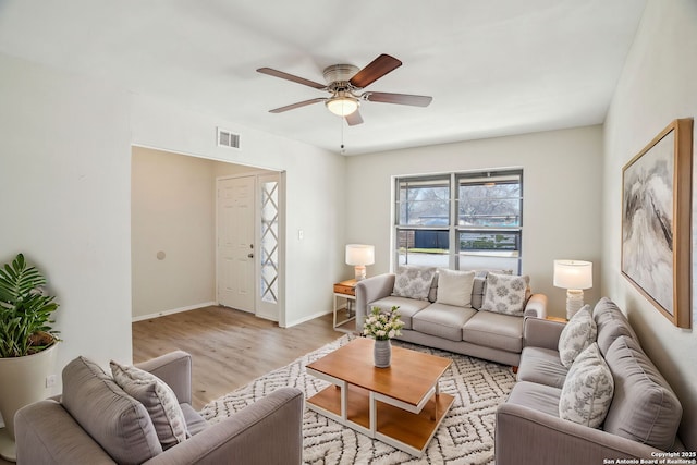 living room with ceiling fan and light hardwood / wood-style floors