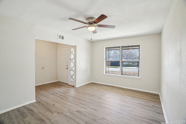 empty room featuring ceiling fan and light hardwood / wood-style floors