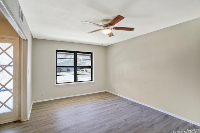 spare room with hardwood / wood-style flooring and ceiling fan