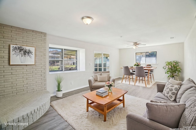 living room featuring ceiling fan and hardwood / wood-style floors