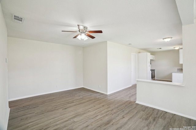 spare room with ceiling fan and wood-type flooring