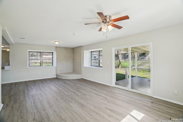 unfurnished living room featuring hardwood / wood-style floors and ceiling fan