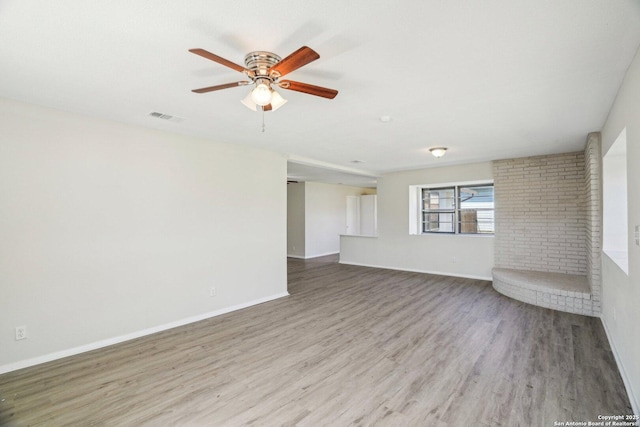 unfurnished room with ceiling fan and light wood-type flooring