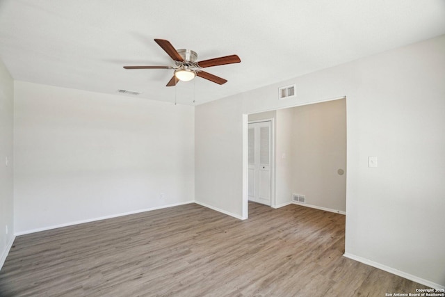 unfurnished room with hardwood / wood-style flooring and ceiling fan