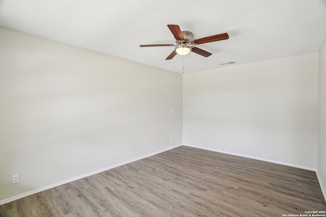 spare room featuring ceiling fan and wood-type flooring