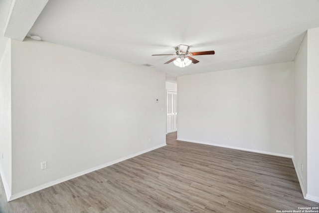 spare room featuring ceiling fan, wood-type flooring, and a textured ceiling