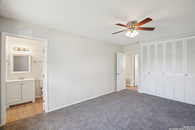 unfurnished bedroom featuring light carpet, ceiling fan, a closet, and connected bathroom