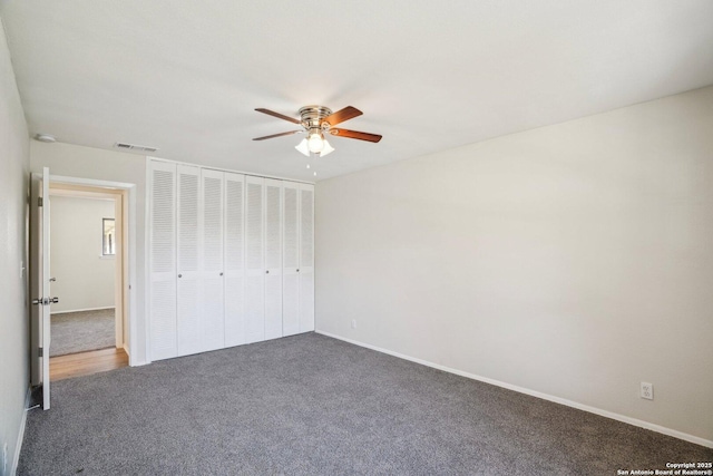 unfurnished bedroom with a closet, ceiling fan, and dark colored carpet