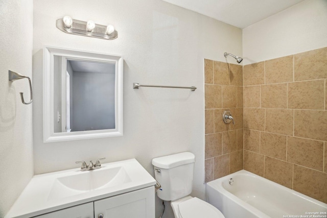 full bathroom featuring toilet, vanity, and tiled shower / bath