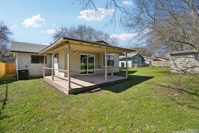 back of house featuring central AC, a patio, and a lawn