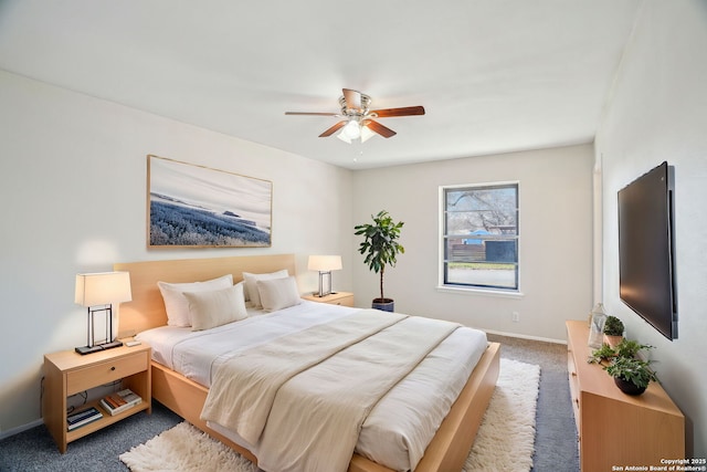 bedroom with ceiling fan and dark colored carpet