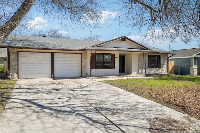 single story home with a garage and a front yard