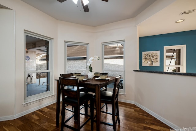 dining room featuring ceiling fan, dark hardwood / wood-style floors, and a healthy amount of sunlight