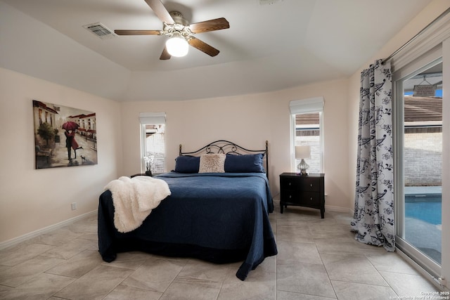 tiled bedroom featuring access to outside, ceiling fan, and a raised ceiling