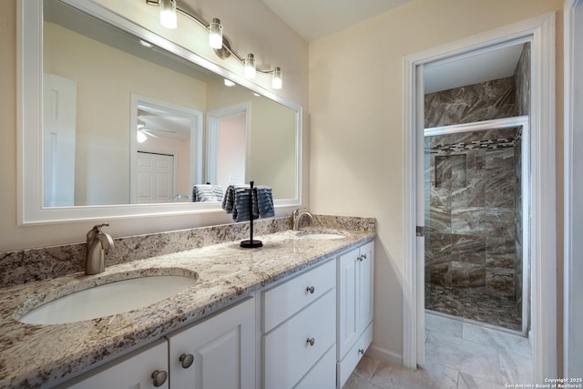 bathroom with a shower with shower door and vanity